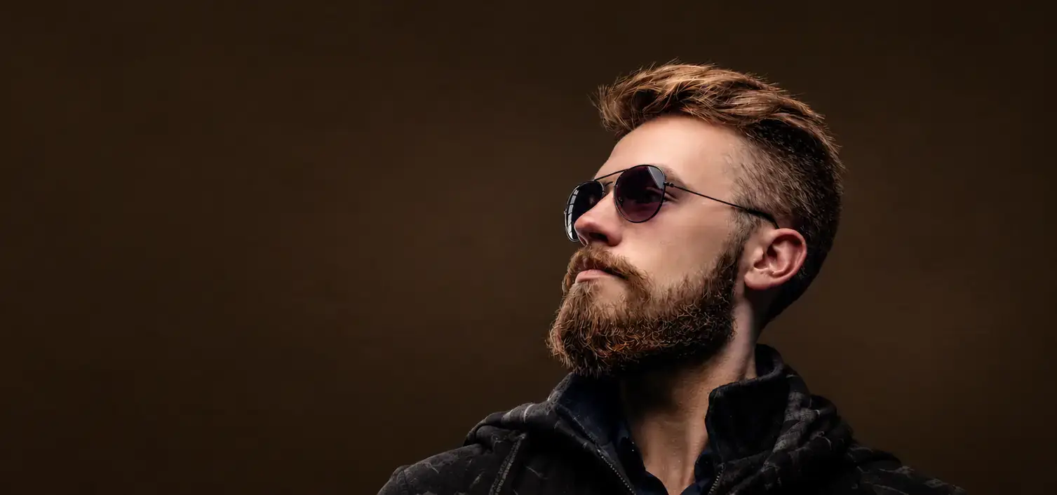Man with a sharp fade and groomed beard